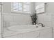 Elegant bathroom with a soaking tub and marble tile at 13008 Weatherstone Dr, Spring Hill, FL 34609