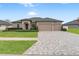 Single-story house, three car garage, paver driveway at 13008 Weatherstone Dr, Spring Hill, FL 34609