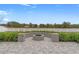 Fire pit with stone seating in a paved backyard area at 13008 Weatherstone Dr, Spring Hill, FL 34609