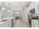 Modern kitchen with white cabinets, stainless steel appliances, and a breakfast nook at 13008 Weatherstone Dr, Spring Hill, FL 34609