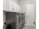 Laundry room with LG washer and dryer and white cabinets at 13008 Weatherstone Dr, Spring Hill, FL 34609