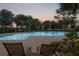 Inviting community pool at sunset, perfect for evening swims at 13008 Weatherstone Dr, Spring Hill, FL 34609