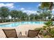 Relaxing community pool with lounge chairs and umbrellas at 13008 Weatherstone Dr, Spring Hill, FL 34609