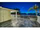 Private balcony with water views and tile flooring at night at 1302 Belcher Dr, Tarpon Springs, FL 34689