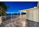 Private balcony with nighttime water views and tile flooring at 1302 Belcher Dr, Tarpon Springs, FL 34689