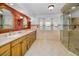 Elegant bathroom with double vanity, walk-in shower, and a window with a view at 1302 Belcher Dr, Tarpon Springs, FL 34689