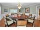 Elegant dining room with large round table and chandelier at 1302 Belcher Dr, Tarpon Springs, FL 34689