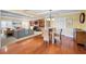 Bright dining room with hardwood floors and a glass table, adjacent to the living room at 1302 Belcher Dr, Tarpon Springs, FL 34689