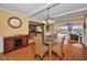 Bright dining room with glass table and kitchen view at 1302 Belcher Dr, Tarpon Springs, FL 34689