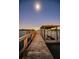 Serene waterfront dock at night under the full moon at 1302 Belcher Dr, Tarpon Springs, FL 34689