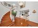 Elegant entryway showcasing a curved staircase and hardwood floors at 1302 Belcher Dr, Tarpon Springs, FL 34689