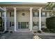 House exterior featuring a grand entrance with columns and a stained glass door at 1302 Belcher Dr, Tarpon Springs, FL 34689