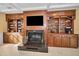 Elegant fireplace with built-in wooden shelving and cabinets at 1302 Belcher Dr, Tarpon Springs, FL 34689