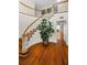 Elegant curved staircase with hardwood floors and white railings at 1302 Belcher Dr, Tarpon Springs, FL 34689