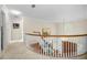 Upper level hallway with carpet, curved railing, and stained glass window at 1302 Belcher Dr, Tarpon Springs, FL 34689