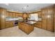 Spacious kitchen with wood cabinets and granite island at 1302 Belcher Dr, Tarpon Springs, FL 34689