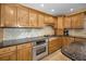 Modern kitchen with wood cabinets and granite counters at 1302 Belcher Dr, Tarpon Springs, FL 34689