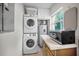 Stackable washer and dryer, microwave, and water heater in the laundry room at 1302 Belcher Dr, Tarpon Springs, FL 34689