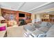 Sunlit living room featuring a comfortable sectional sofa and built-in entertainment center at 1302 Belcher Dr, Tarpon Springs, FL 34689