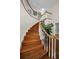 Wooden curved staircase in a bright, spacious entryway at 1302 Belcher Dr, Tarpon Springs, FL 34689