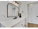 Modern bathroom with white cabinets and a large vanity mirror at 1320 Dixie S Ln, St Petersburg, FL 33707