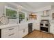 Modern white kitchen with stainless steel appliances and quartz countertops at 1320 Dixie S Ln, St Petersburg, FL 33707