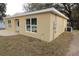 Newly built tan house with gravel driveway and grassy yard at 156 Grand Ave, Brooksville, FL 34604