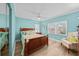 Spacious bedroom with light blue walls and wooden furniture at 1582 Gulf Blvd # 1108, Clearwater Beach, FL 33767