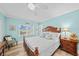 Bright bedroom with light blue walls and wooden furniture at 1582 Gulf Blvd # 1108, Clearwater Beach, FL 33767