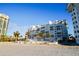 White building exterior with palm trees and beach views at 1582 Gulf Blvd # 1108, Clearwater Beach, FL 33767