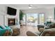 Bright living room with fireplace and balcony access at 1582 Gulf Blvd # 1108, Clearwater Beach, FL 33767