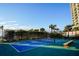 Outdoor paddle tennis court with benches near resort and beach at 1582 Gulf Blvd # 1108, Clearwater Beach, FL 33767