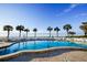 Resort-style pool with palm trees and ocean view at 1582 Gulf Blvd # 1108, Clearwater Beach, FL 33767