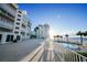 Community pool deck area with ocean views and building in background at 1582 Gulf Blvd # 1108, Clearwater Beach, FL 33767