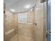 Large walk-in shower with glass enclosure and built-in seat at 1582 Gulf Blvd # 1108, Clearwater Beach, FL 33767