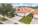 Single-Gathering home with tile roof and brick driveway at 16051 Golden Lakes Dr, Wimauma, FL 33598