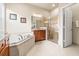 Bathroom featuring a large soaking tub and walk-in shower at 16051 Golden Lakes Dr, Wimauma, FL 33598