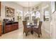 Bright breakfast nook features a glass table and wicker chairs, perfect for morning coffee at 16051 Golden Lakes Dr, Wimauma, FL 33598