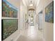 Light-filled entryway, tile floors, and artwork on the walls at 16051 Golden Lakes Dr, Wimauma, FL 33598