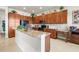 Well-equipped kitchen with granite countertops and wood cabinets at 16051 Golden Lakes Dr, Wimauma, FL 33598