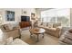 Relaxing living room featuring neutral furniture and large windows at 16051 Golden Lakes Dr, Wimauma, FL 33598