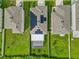 Aerial view showcasing houses with solar panels and screened enclosures at 17048 Oval Rum Dr, Wimauma, FL 33598