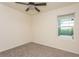 Empty bedroom with carpeted floor, ceiling fan, and window at 17048 Oval Rum Dr, Wimauma, FL 33598