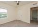 Bedroom with ceiling fan and large window at 17048 Oval Rum Dr, Wimauma, FL 33598