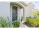 Charming front door entrance with well-maintained landscaping at 17048 Oval Rum Dr, Wimauma, FL 33598