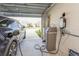 Garage with electric vehicle charger and water softener system at 17048 Oval Rum Dr, Wimauma, FL 33598