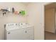 Laundry room with washer, dryer, and shelving at 17048 Oval Rum Dr, Wimauma, FL 33598