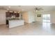 Open living room and kitchen with tile floors at 17048 Oval Rum Dr, Wimauma, FL 33598