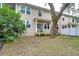 Townhome's private backyard with wooden deck and mature trees at 208 Elm View Ct, Brandon, FL 33511