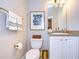 Stylish bathroom with white vanity, granite countertop and gold fixtures at 208 Elm View Ct, Brandon, FL 33511